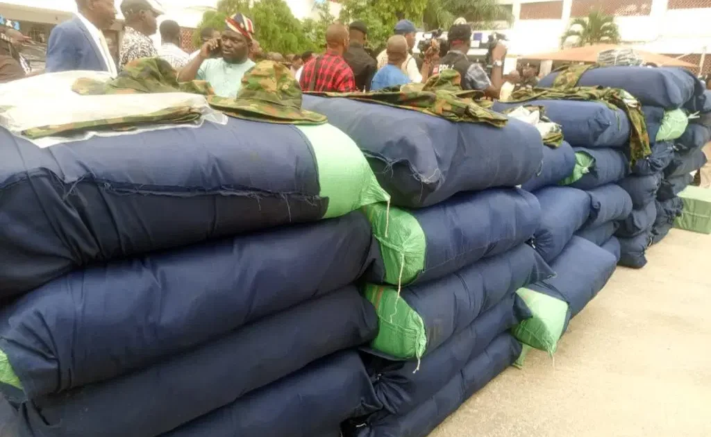 Police display of seized military camouflage uniforms and illicit drugs in Lagos