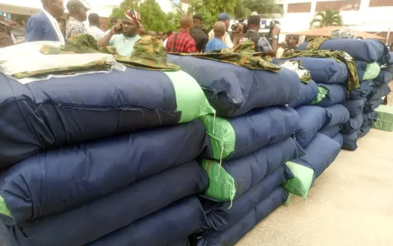 Police display of seized military camouflage uniforms and illicit drugs in Lagos