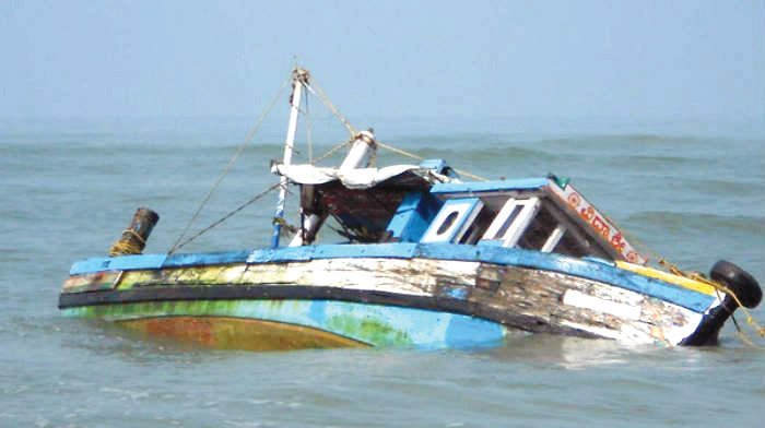 A capsized wooden boat floating in open water after a boat mishap on River Benue in Makurdi.