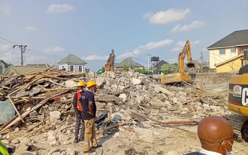 Rescue officials and excavators at the Port Harcourt building collapse site