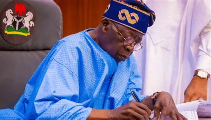 President Bola Tinubu signing documents