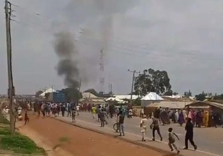 Smoke rises as residents gather during unrest in Maraban Jos, Kaduna State