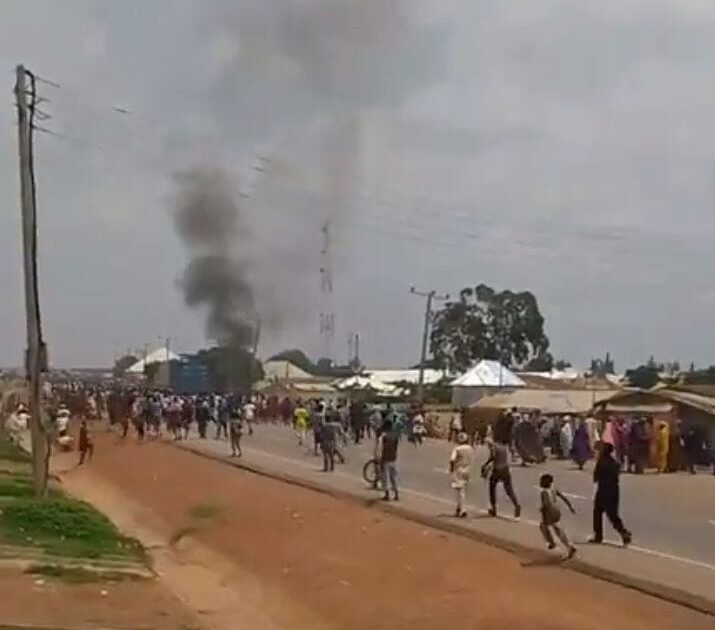 Smoke rises as residents gather during unrest in Maraban Jos, Kaduna State