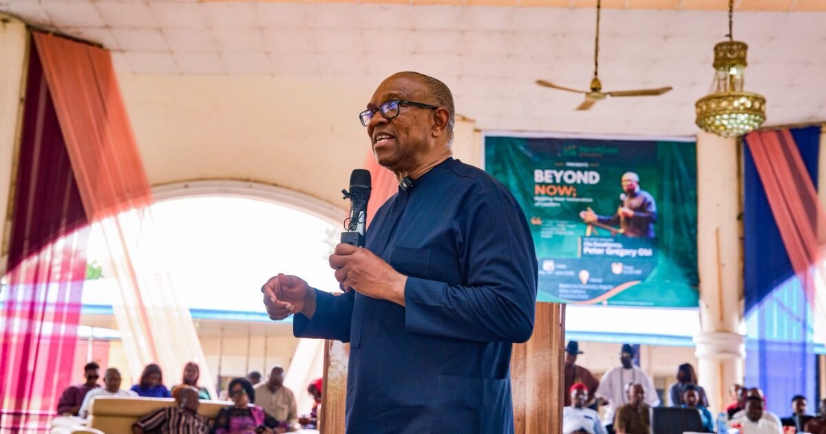 Peter Obi speaking at an indoor event with a microphone