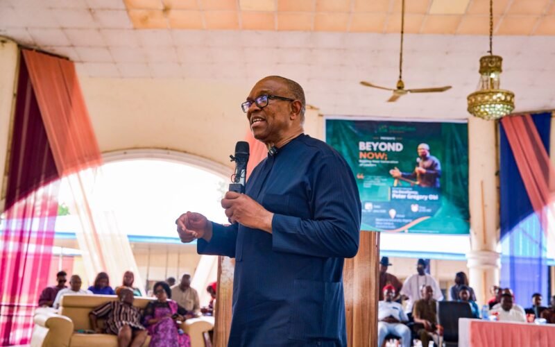 Peter Obi speaking at an indoor event with a microphone