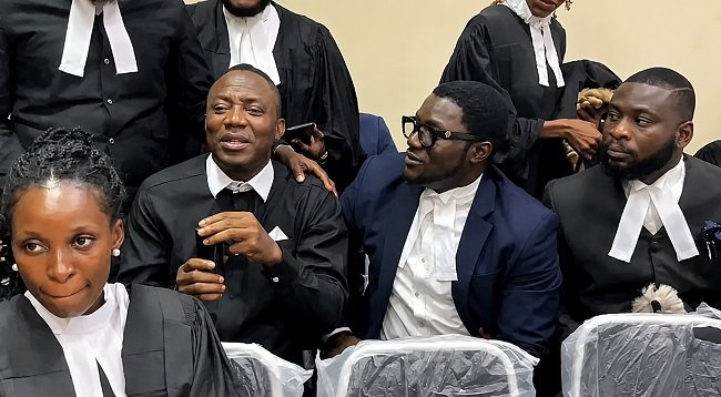 Omoyele Sowore seated in court with lawyers