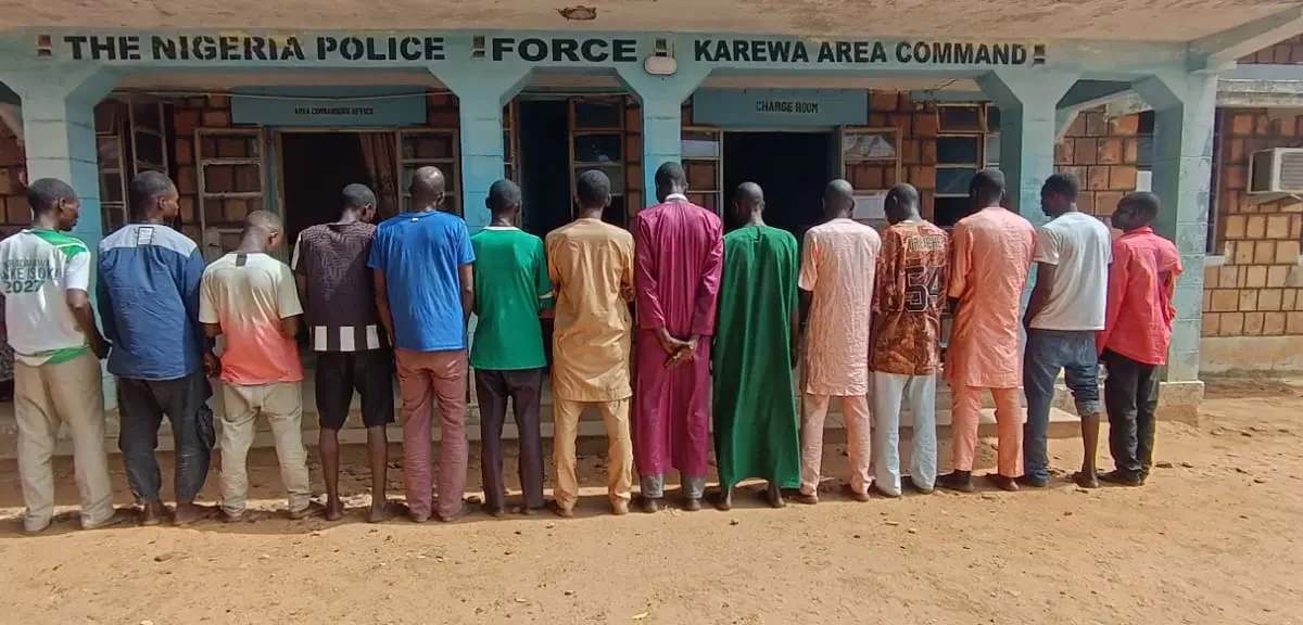 Suspects lined up outside a Nigerian Police Force area command in Adamawa