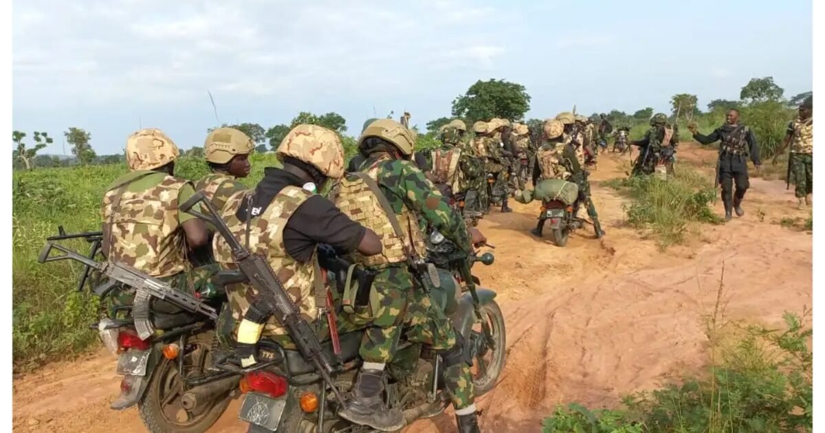 Nigerian troops on motorcycles during a security operation in rural terrain