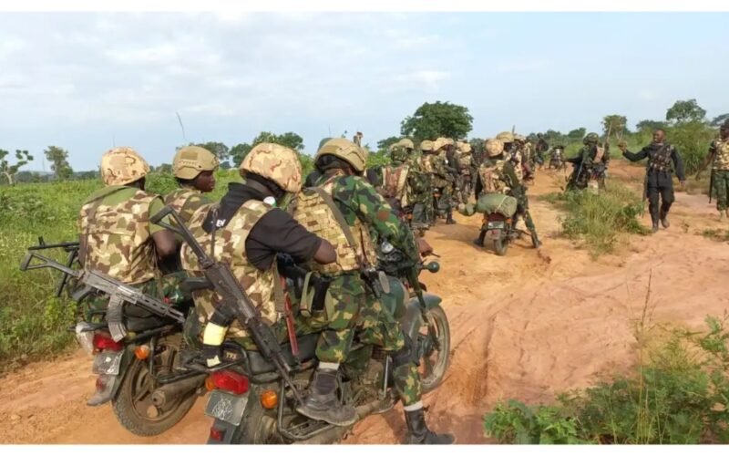 Nigerian troops on motorcycles during a security operation in rural terrain