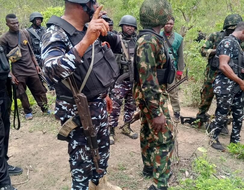 Security operatives and local hunters in a forest area, used for Kogi abduction search story
