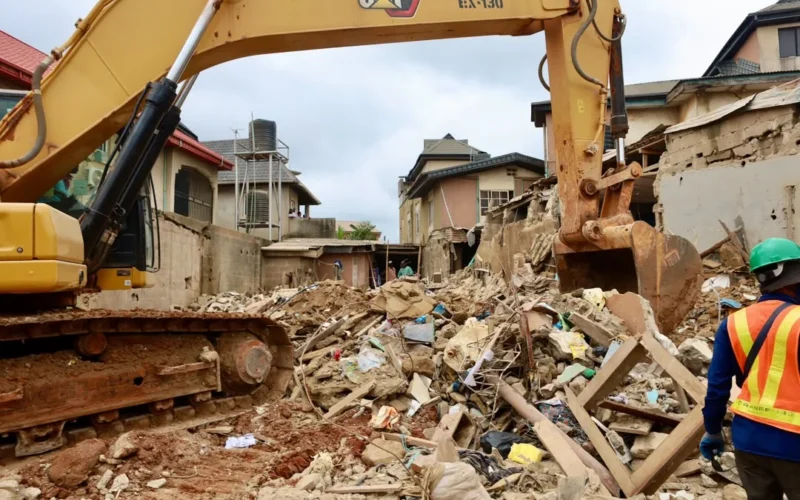 Rubble and excavation equipment at the Ajuwon building collapse scene in Ogun State.