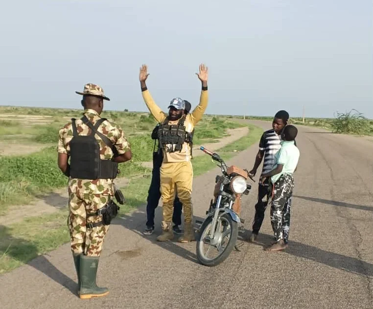 Source photo showing a surrendered ISWAP finance operative with troops in Borno