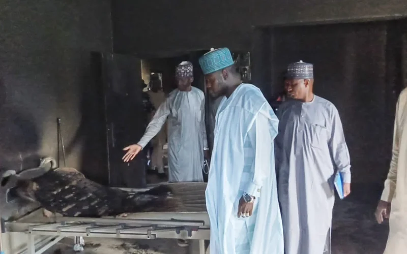 Ngala local government chairman inspecting a burnt facility after an attack in Logomani, Borno