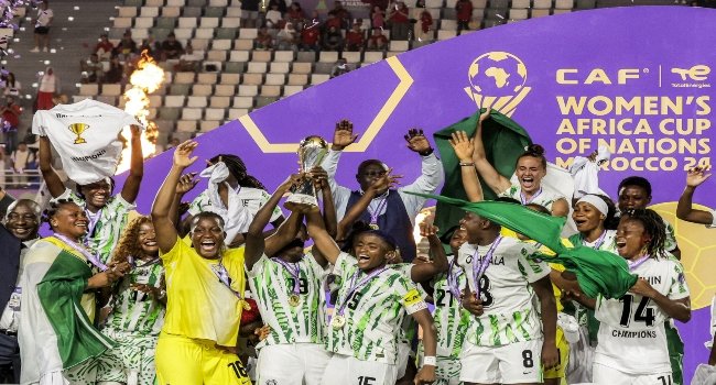 Super Falcons players celebrate with the WAFCON trophy
