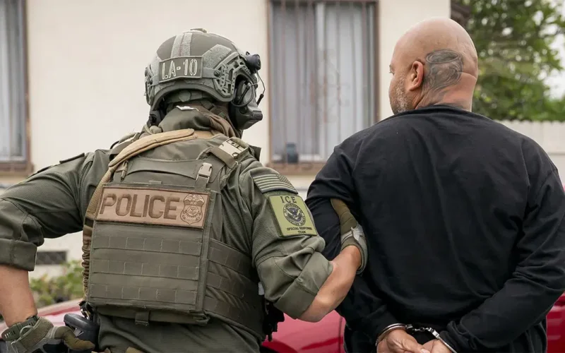 US immigration enforcement officer detaining a man