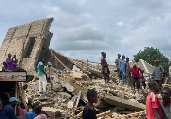 Collapsed building and residents at the Sokoto construction site