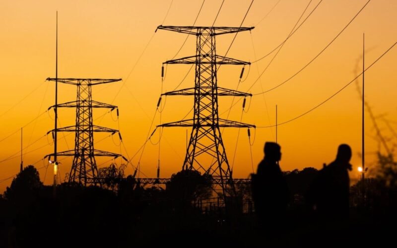Transmission towers at sunset used as a power outage illustration
