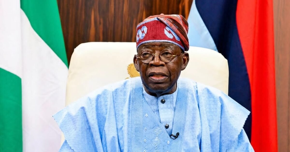 President Bola Tinubu seated before national flags