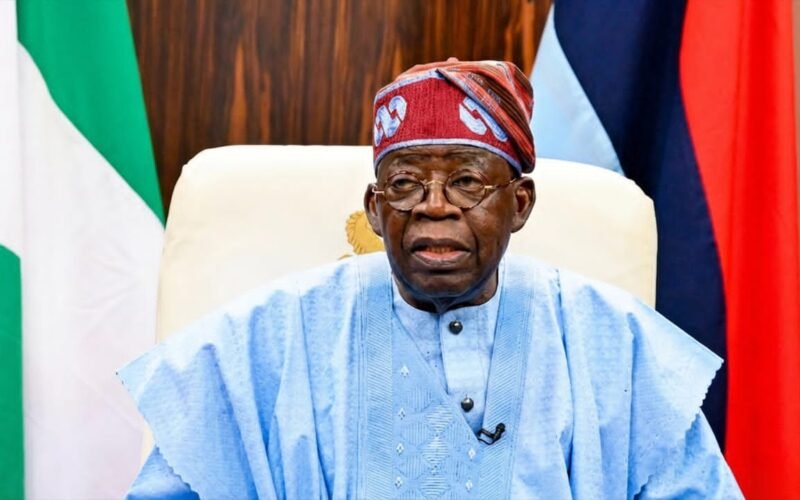 President Bola Tinubu seated before national flags