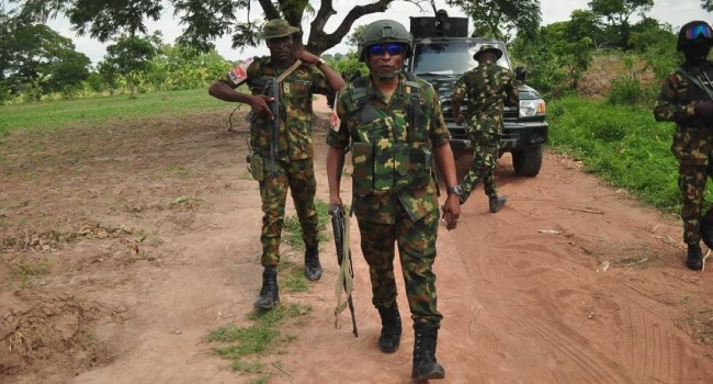 Nigerian troops on patrol along a rural road