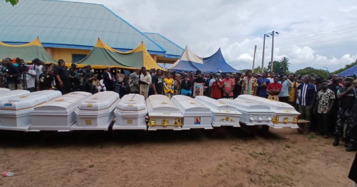 Caskets and mourners at the burial of victims in Efeyi-Utikpi, Benue State
