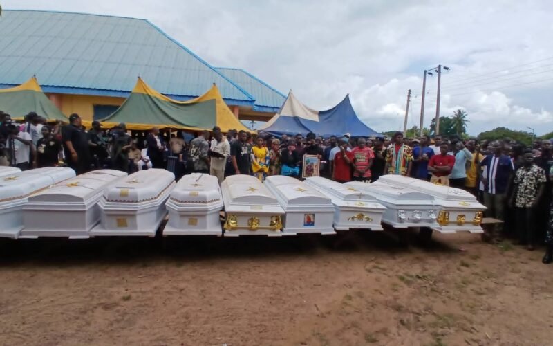 Caskets and mourners at the burial of victims in Efeyi-Utikpi, Benue State