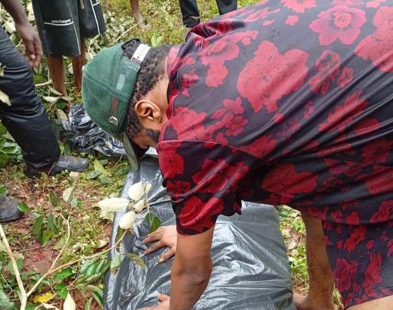 People at the forest site where troops exhumed the covered remains of Chief Ibe Anyadu
