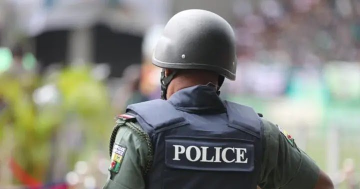 A Nigerian police officer seen from behind during security duty