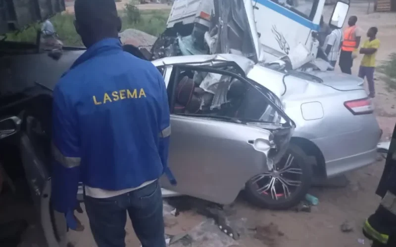 LASEMA responders stand near a damaged car and truck after the Lagos-Badagry Expressway crash.