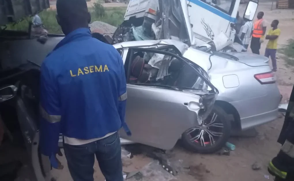LASEMA responders stand near a damaged car and truck after the Lagos-Badagry Expressway crash.