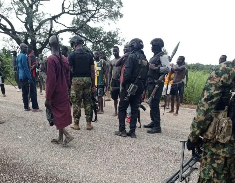 Security personnel and civilians during an Operation Fansan Yamma field operation