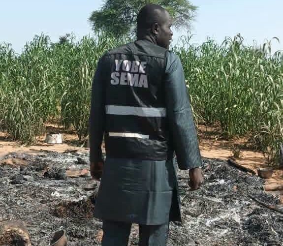 Yobe SEMA official inspecting fire damage at Rugar Audu Badali in Karasuwa, Yobe State