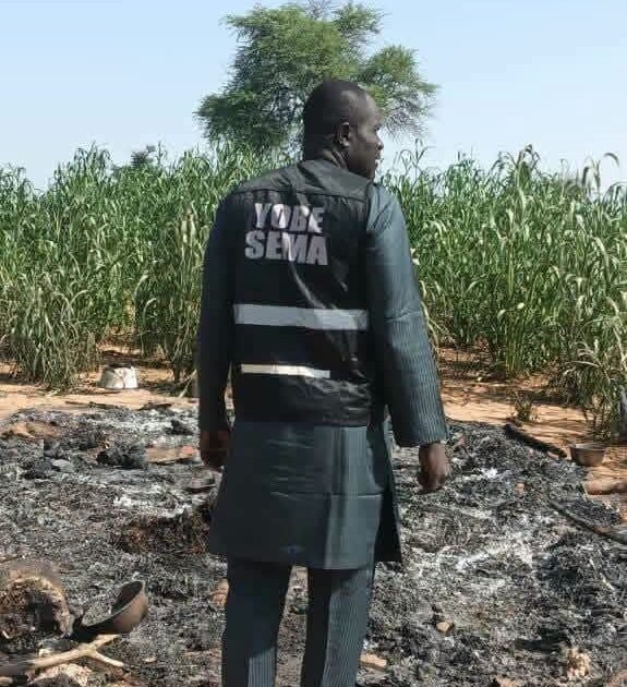 Yobe SEMA official inspecting fire damage at Rugar Audu Badali in Karasuwa, Yobe State