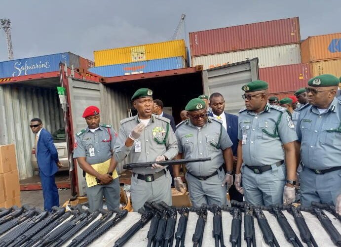 Nigeria Customs officials display seized pump-action rifle components at Tin Can Island Port in Lagos