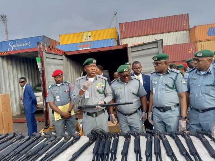 Nigeria Customs officials display seized pump-action rifle components at Tin Can Island Port in Lagos