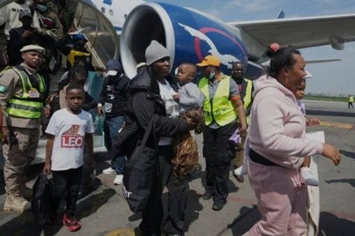 Nigerian evacuees near an aircraft during a South Africa return movement