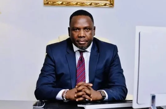 Daniel Bwala, a presidential aide, seated at a desk