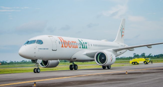 An Ibom Air aircraft on an airport runway.