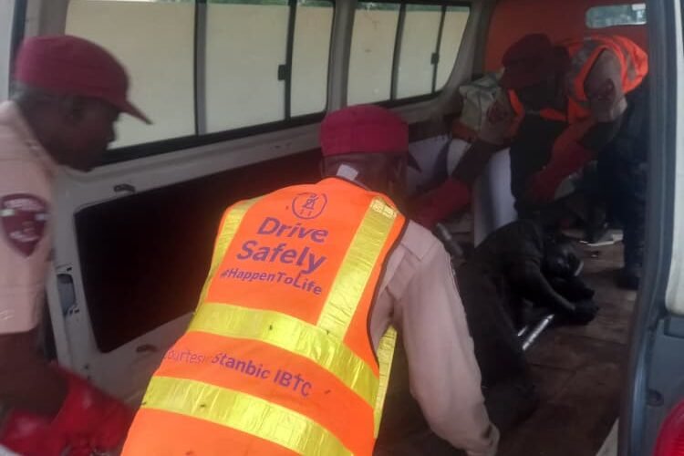 FRSC officials helping a crash victim after a trailer crash on the Kano-Zaria Road