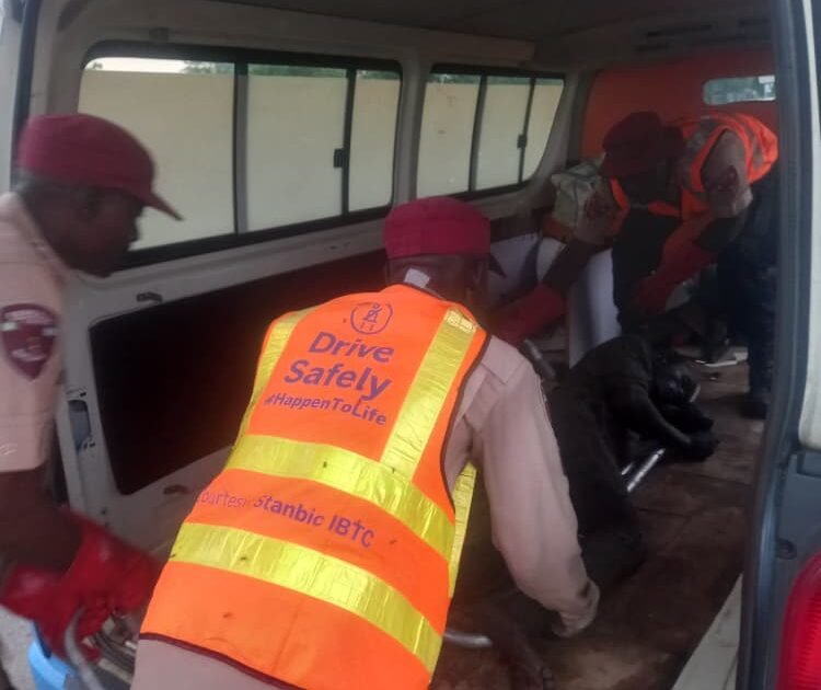 FRSC officials helping a crash victim after a trailer crash on the Kano-Zaria Road