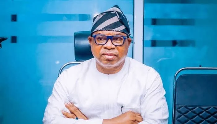 Bola Oyebamiji seated in traditional cap and white attire