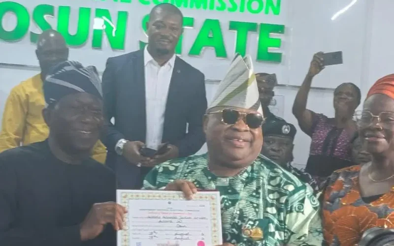Osun Governor Ademola Adeleke holds his certificate of return at the INEC office in Osogbo