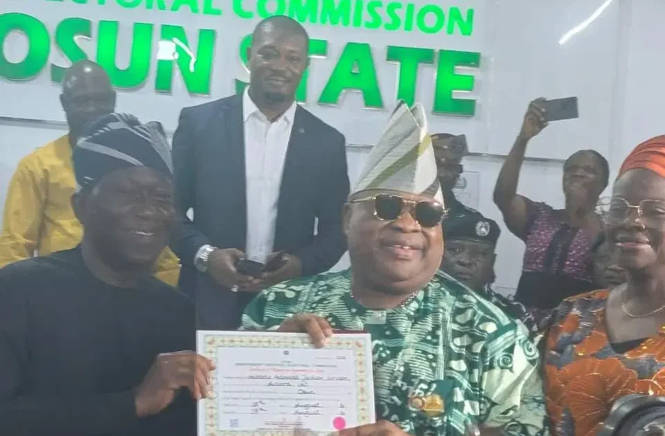 Osun Governor Ademola Adeleke holds his certificate of return at the INEC office in Osogbo