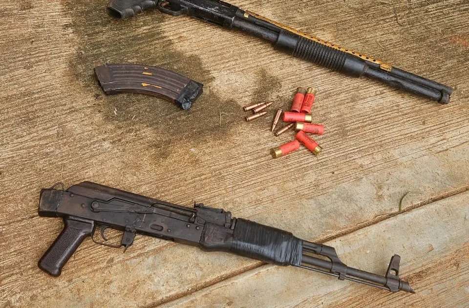 Recovered AK-47 rifle, pump-action gun, magazine and ammunition displayed by Anambra police