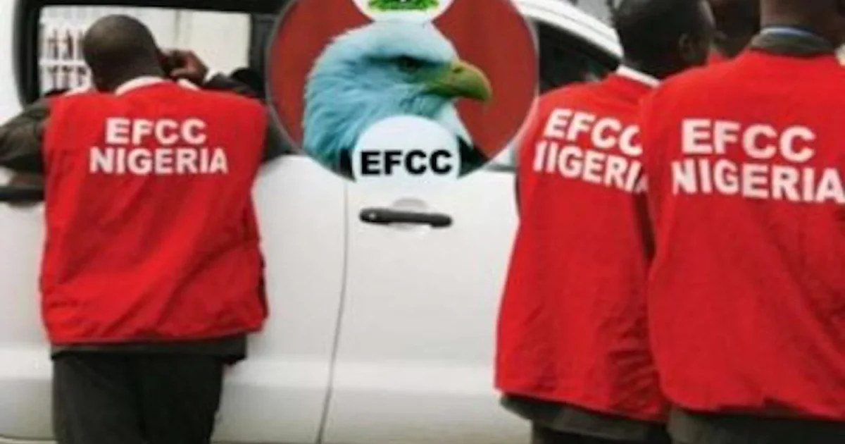 EFCC operatives beside an agency vehicle.