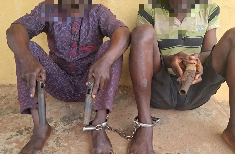 Two arrested robbery suspects with recovered locally made pistols in Ogun State