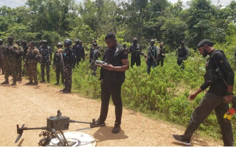 Security personnel and a drone during a forest search operation in Kogi State.