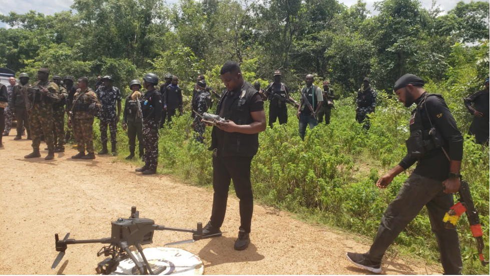 Security personnel and a drone during a forest search operation in Kogi State.