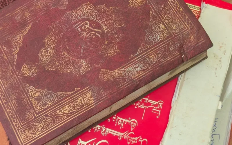 Source-origin Punch photo showing a Qur’an and papers linked to the report. Used carefully as exact source imagery for the alleged desecration arrest story.