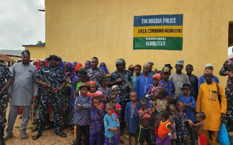 Rescued Kaduna travellers and police officers outside the Birnin Gwari Area Command headquarters